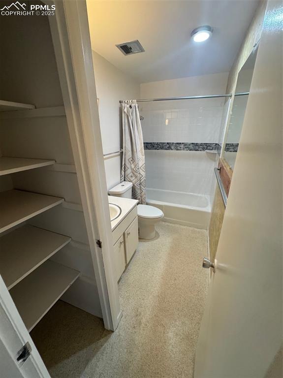 Bathroom featuring vanity and shower / bath combination with curtain