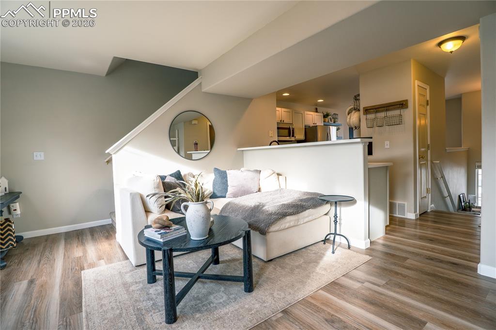 Living area with light wood-style flooring and recessed lighting