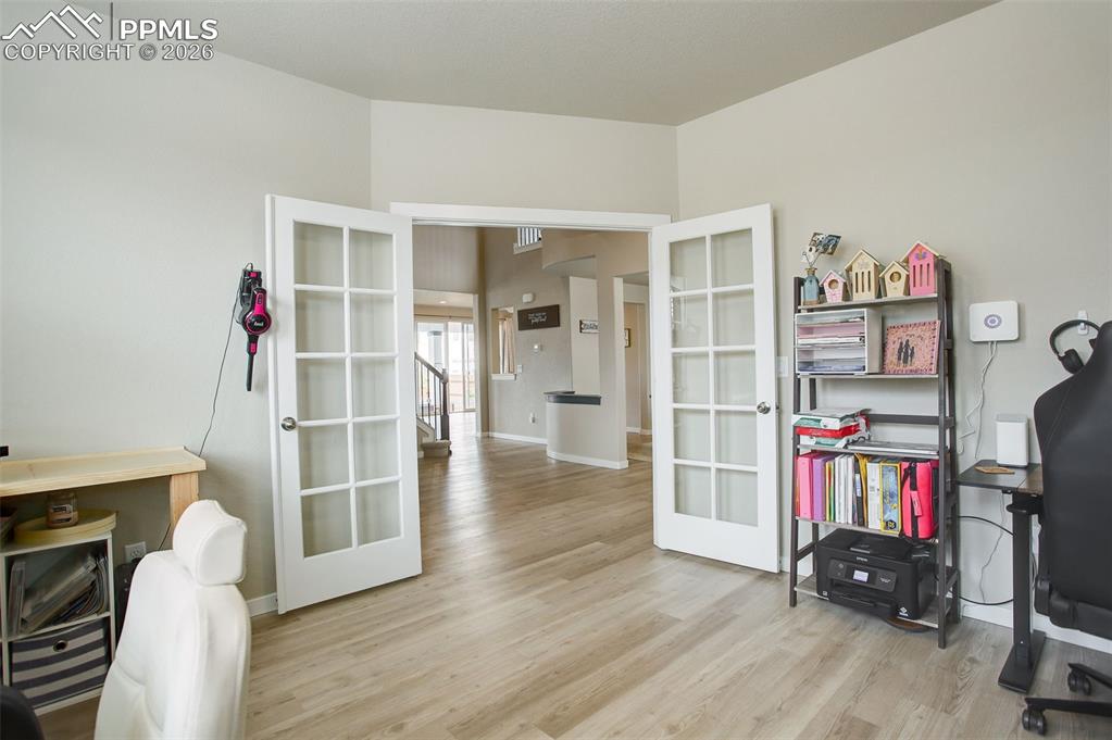 Main level office; french doors, LVP flooring, and loads of natural light