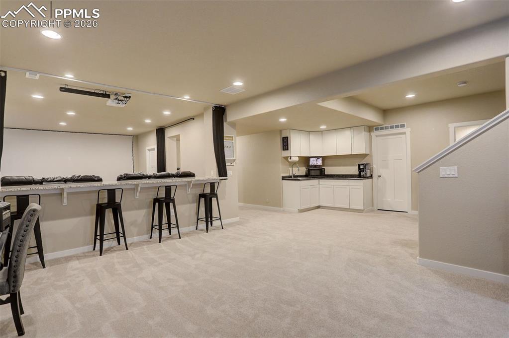 Lower level; basement - counter-height stone top seating/entertainment area, wet-bar with stone top, additional cabinetry and storage, utility room, and tons of recessed lighting. Upgraded, plush carpet. Additional theater/snack bar.