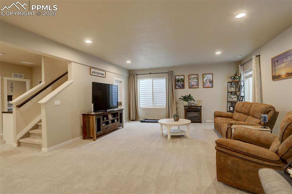 Lower Level; Living room, oversized windows, and deep walk-in storage closet