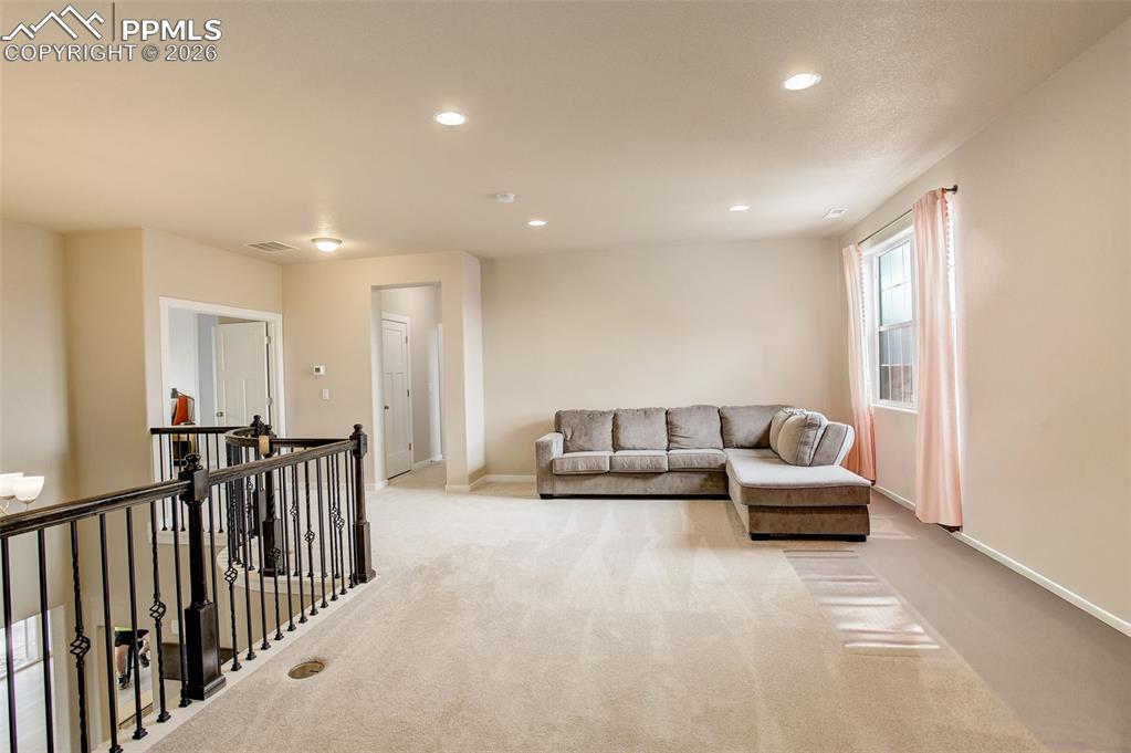Living room with recessed lighting and carpet, spacious and bright 