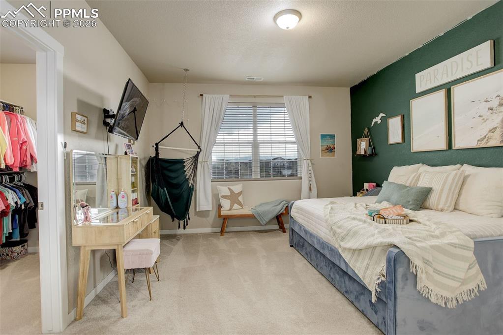 Upstairs/West facing large Bedroom featuring a walk-in close and adjoining bathroom