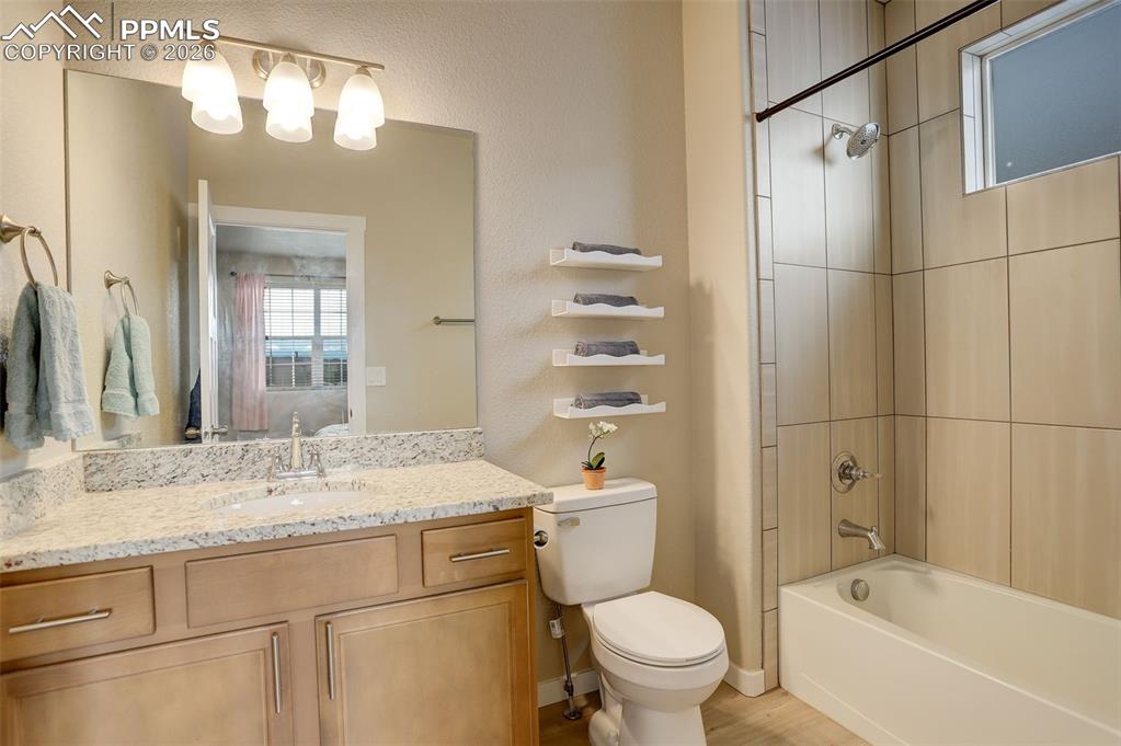 Carpeted bedroom featuring baseboards and connected bathroom