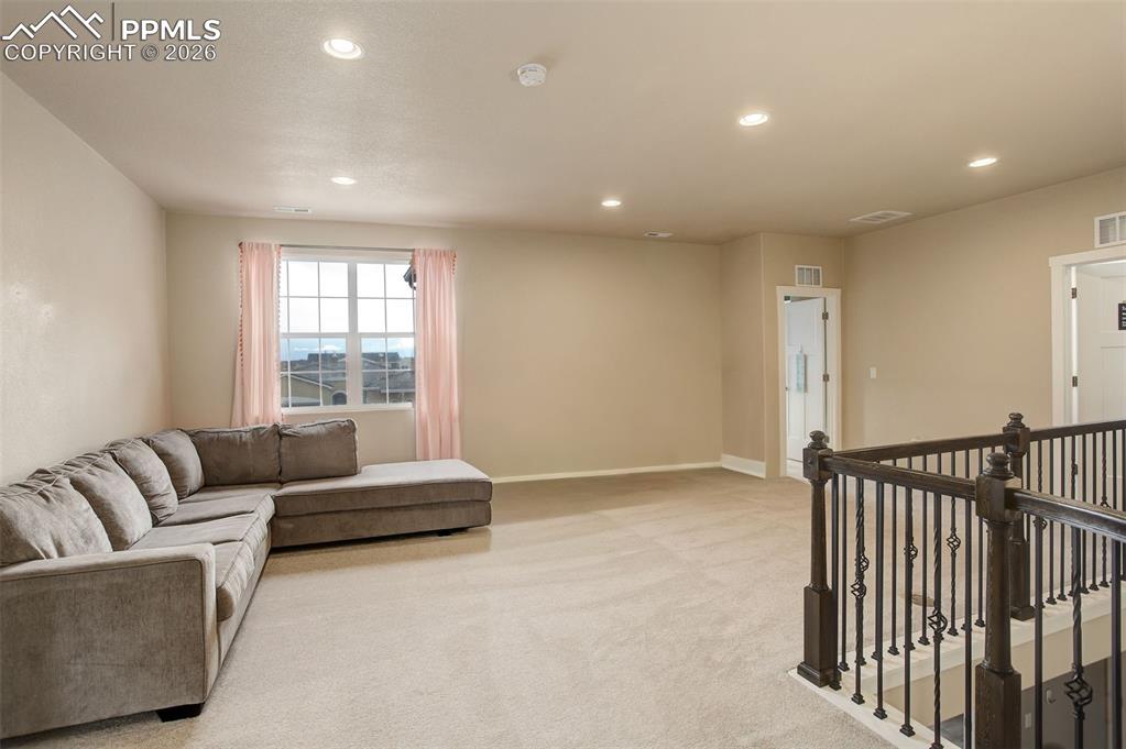 Living room with recessed lighting and carpet, spacious and bright 