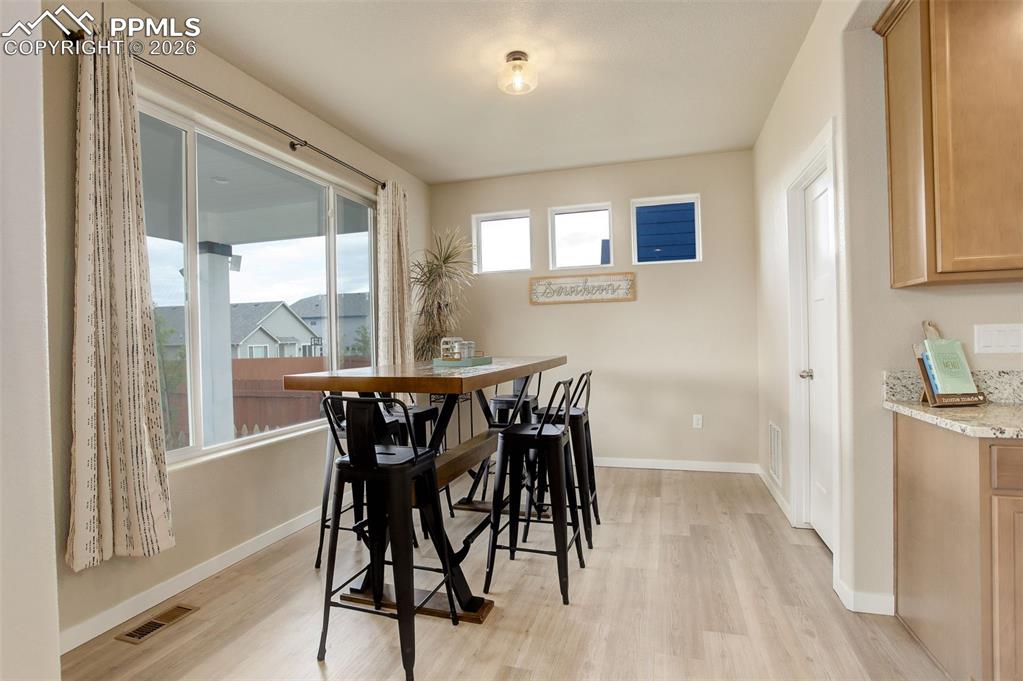 Dining area adjoining kitchen - near walkin pantry and more oversized windows.