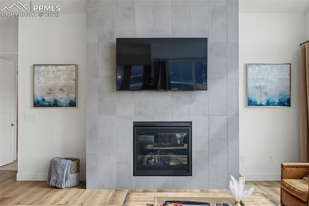 Detailed view of wood finished floors and a fireplace