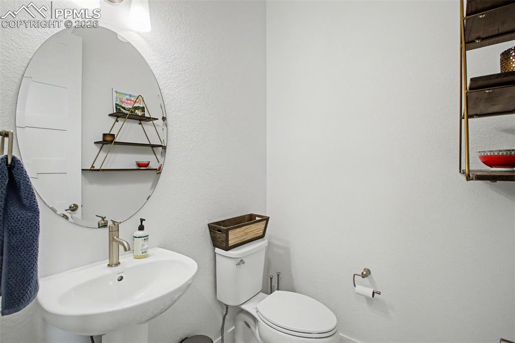 Half bath featuring a textured wall