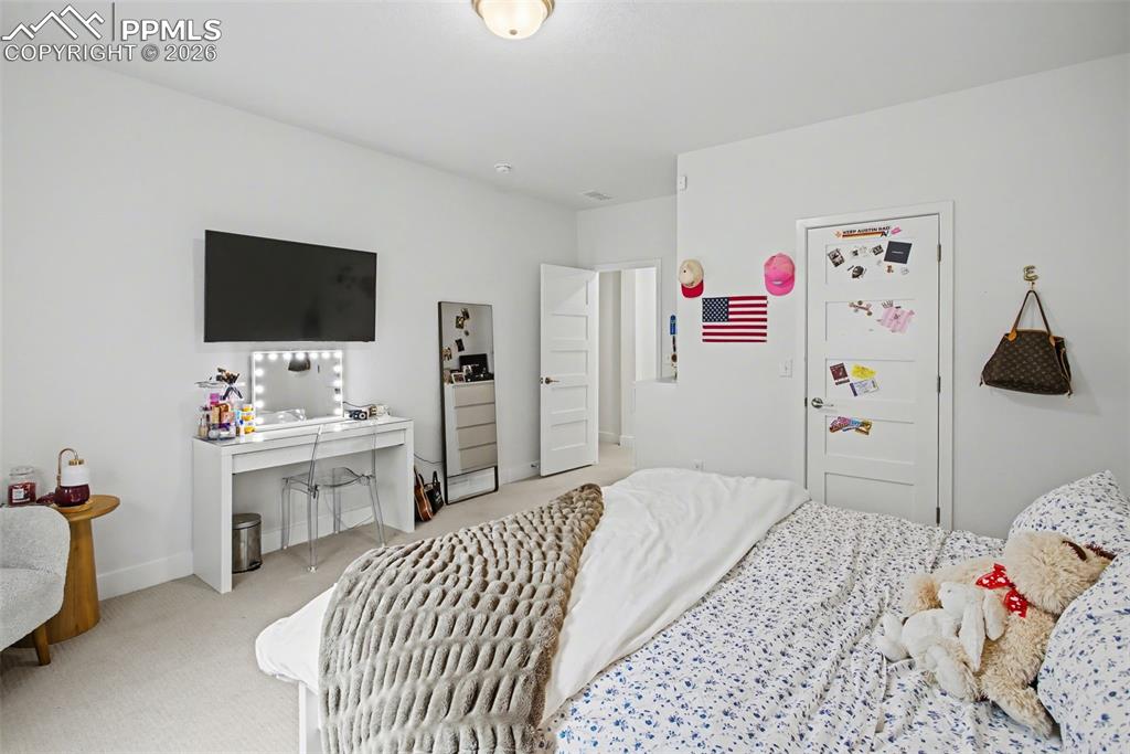 Bedroom with light carpet and baseboards