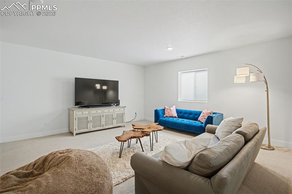 Carpeted living room featuring baseboards