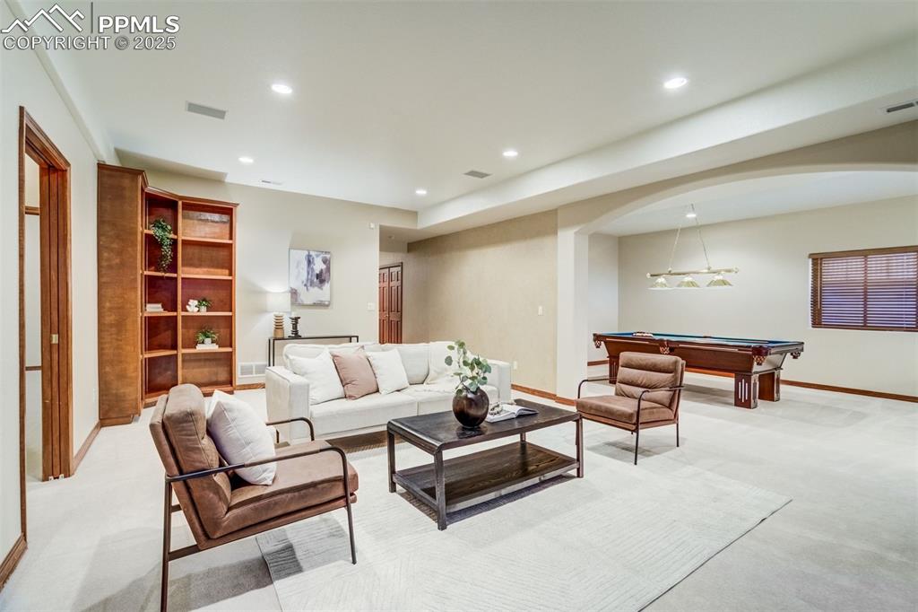 Family room in the basement with extended height ceilings. 