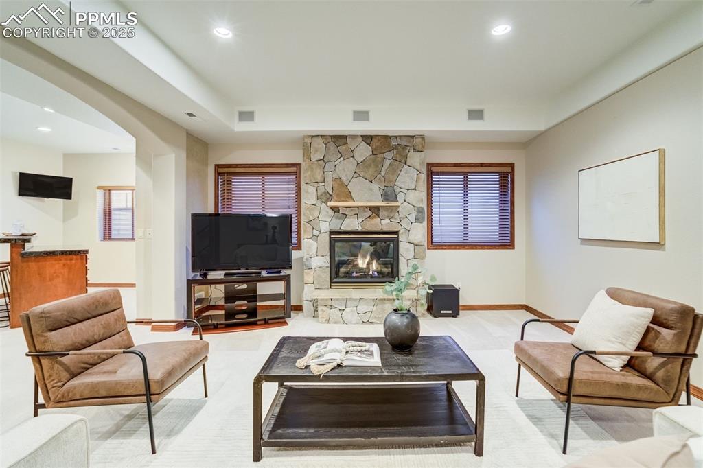 Gas fireplace with stone surround in the basement. 