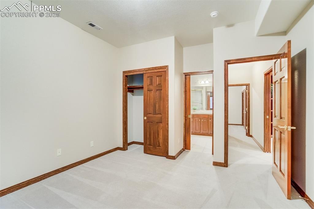 Bedroom 2 in the basement with access to the Jack-N-Jill bathroom.
