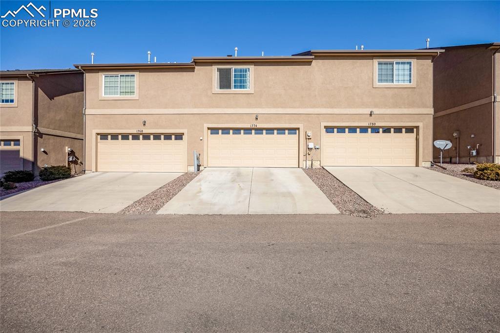 Two-car garage townhome with low-maintenance exterior and great curb appeal.