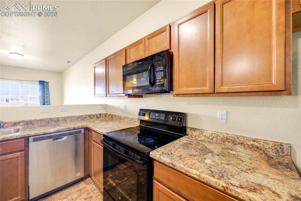 Modern U-shaped layout with plenty of counter space for cooking and prep.
