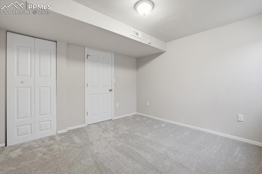 Unfurnished bedroom featuring carpet and a closet