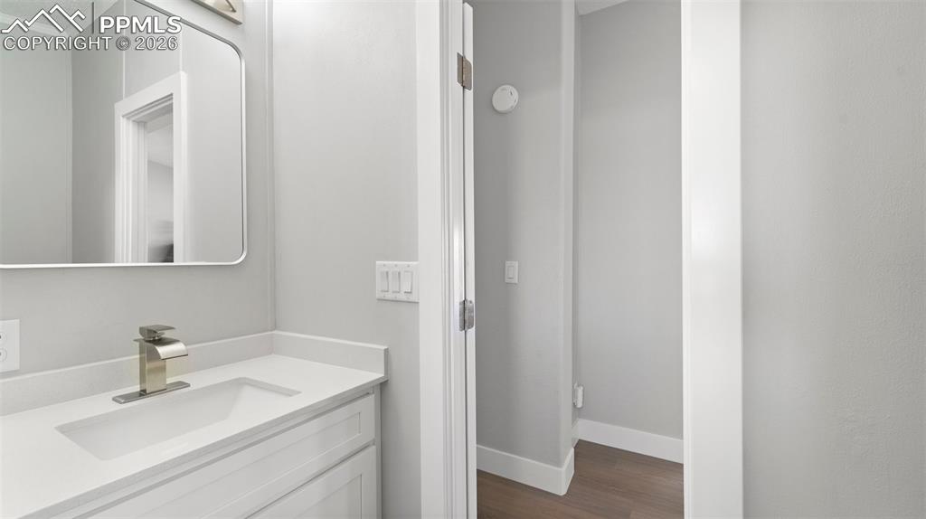 Bathroom with hardwood / wood-style flooring and vanity