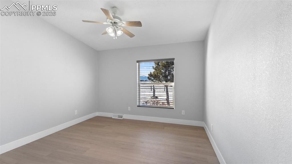Spare room with light hardwood / wood-style floors and ceiling fan