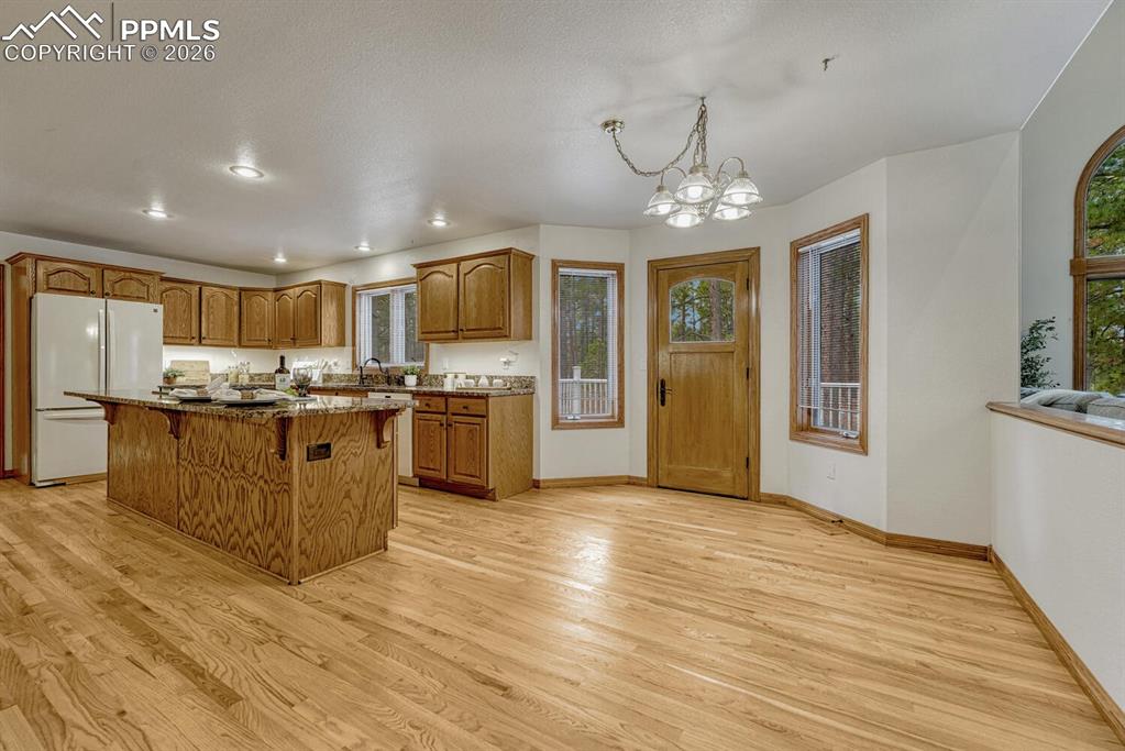 The Gourmet Island Kitchen has a breakfast nook for informal dining and a walk out to the backyard composite deck.