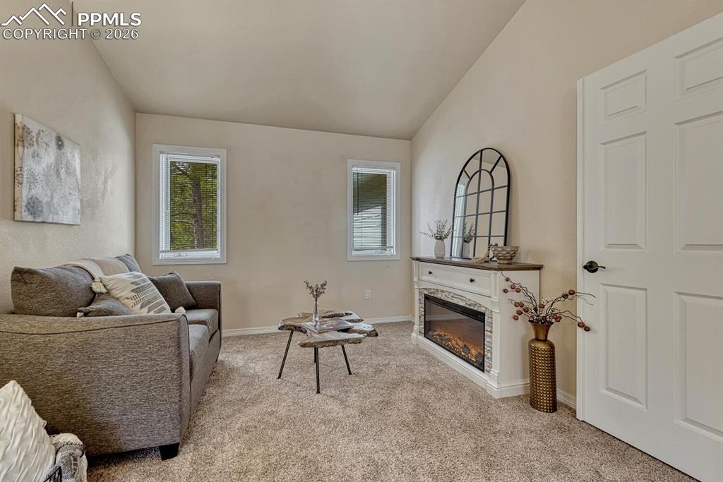 Sitting Room in the Upper Level Primary Suite that includes an electric fireplace to cozy up on chilly Colorado evenings. 