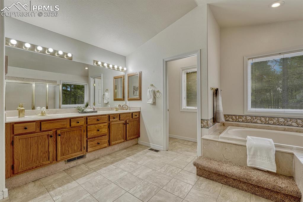 5pc Primary Bathroom with dual sink vanity with engineered marble countertops, mirror, and Jacuzzi tub.