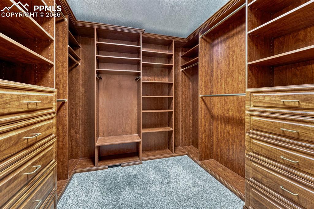 Custom built walk-in closet in the Primary Bedroom.