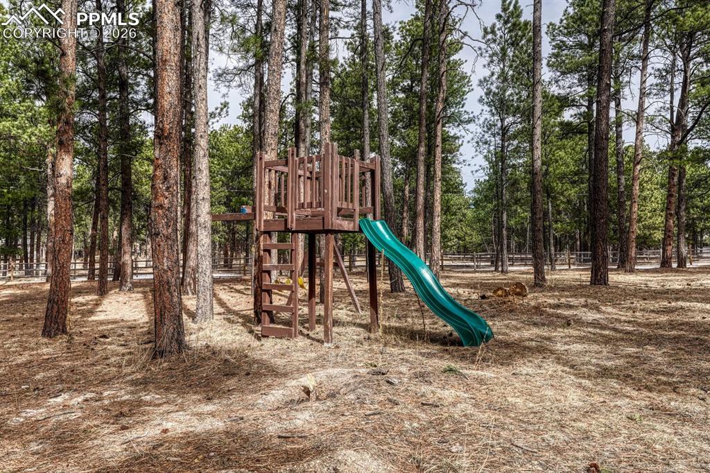Tree fort and slide for the kids is included.