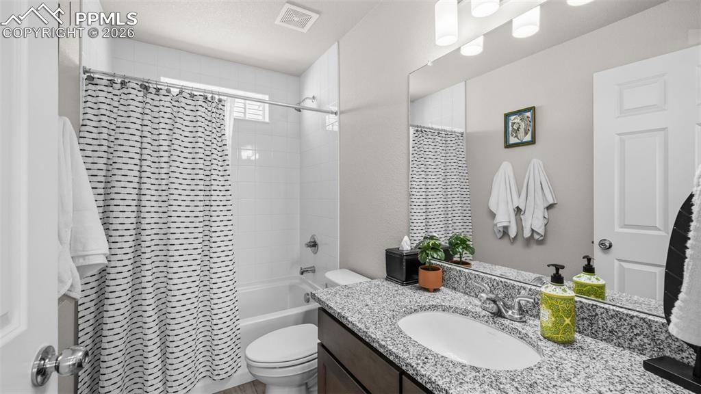 Full bathroom with vanity and shower / bathtub combination with curtain