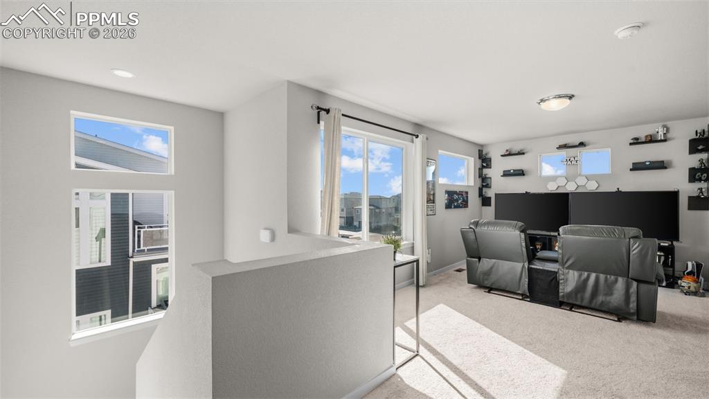 Living area featuring light carpet