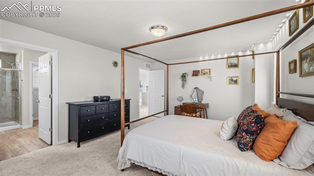 Bedroom with light colored carpet
