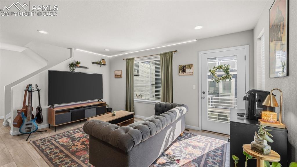 Living room with light wood-style floors and recessed lighting