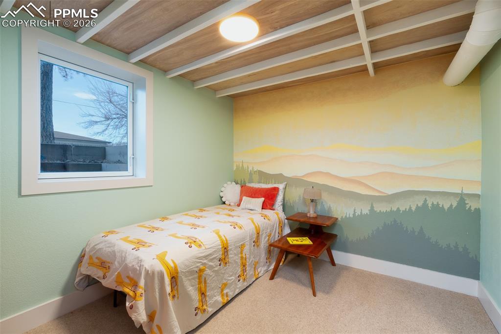 One of two basement bedrooms with hand painted mural and egress window