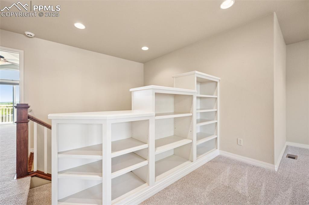 Hall with carpet and recessed lighting