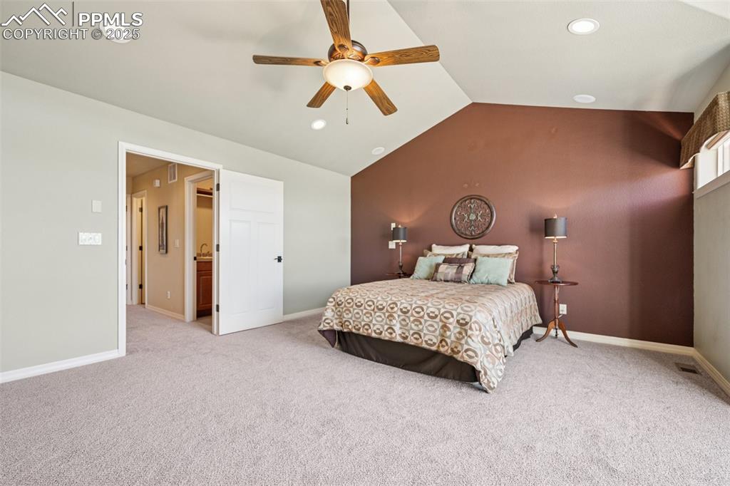 Bedroom featuring light carpet, lofted ceiling, recessed lighting, and ceiling fan