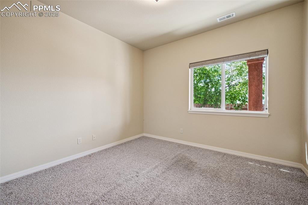 Empty room with carpet floors and baseboards