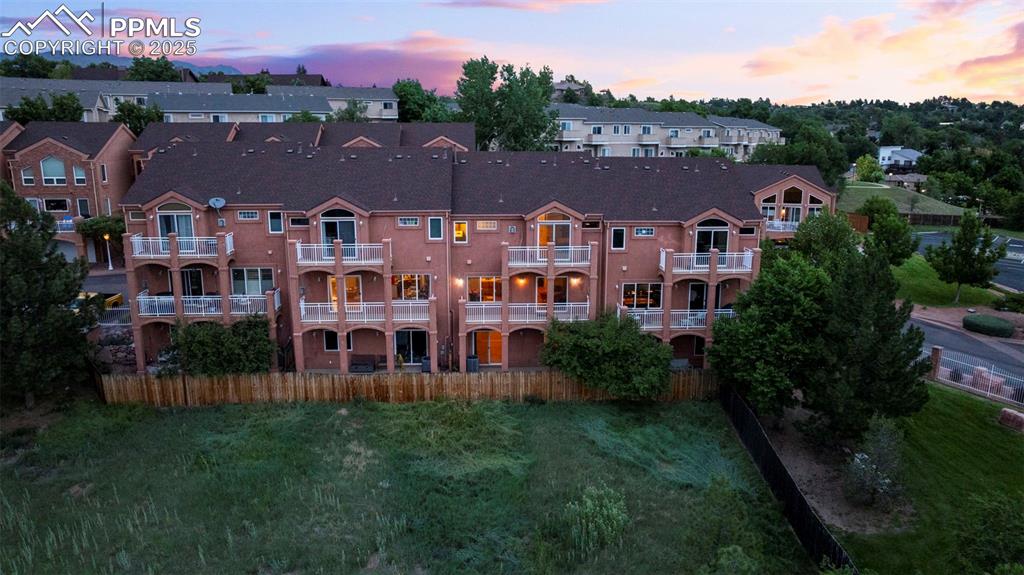 View of property at dusk