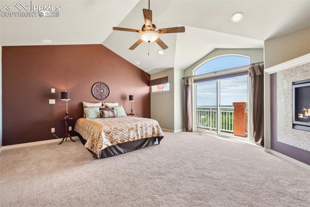 Bedroom with lofted ceiling, access to outside, carpet, a ceiling fan, and recessed lighting