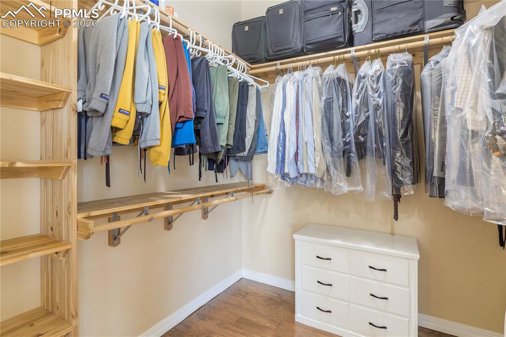 Custom walk-in closet with cedar wood shelving and hickory wood floors. 
