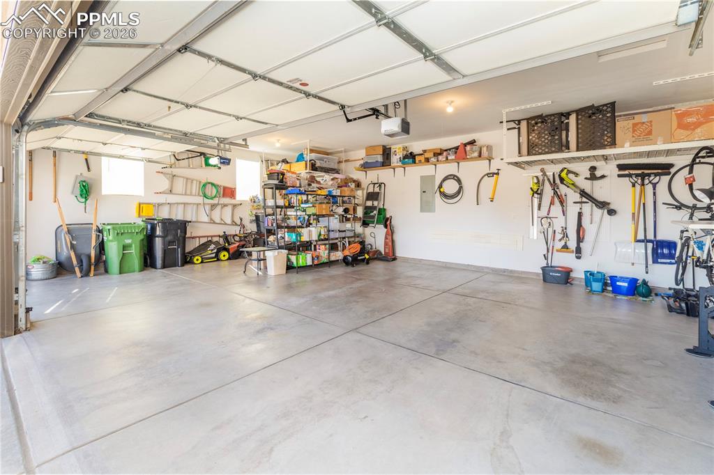 Finished and insulated 30'W x 21'L garage includes hanging storage racks.