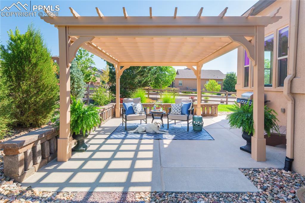 Expanded patio with custom pergola and outdoor lounge area.