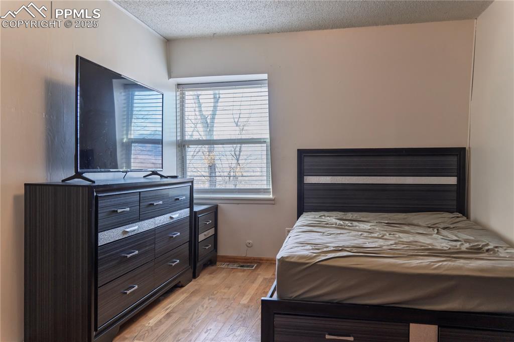 Bedroom featuring light wood-style flooring and a textured ceiling