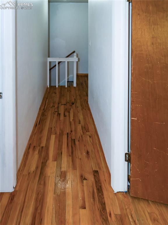 Hallway featuring wood finished floors
