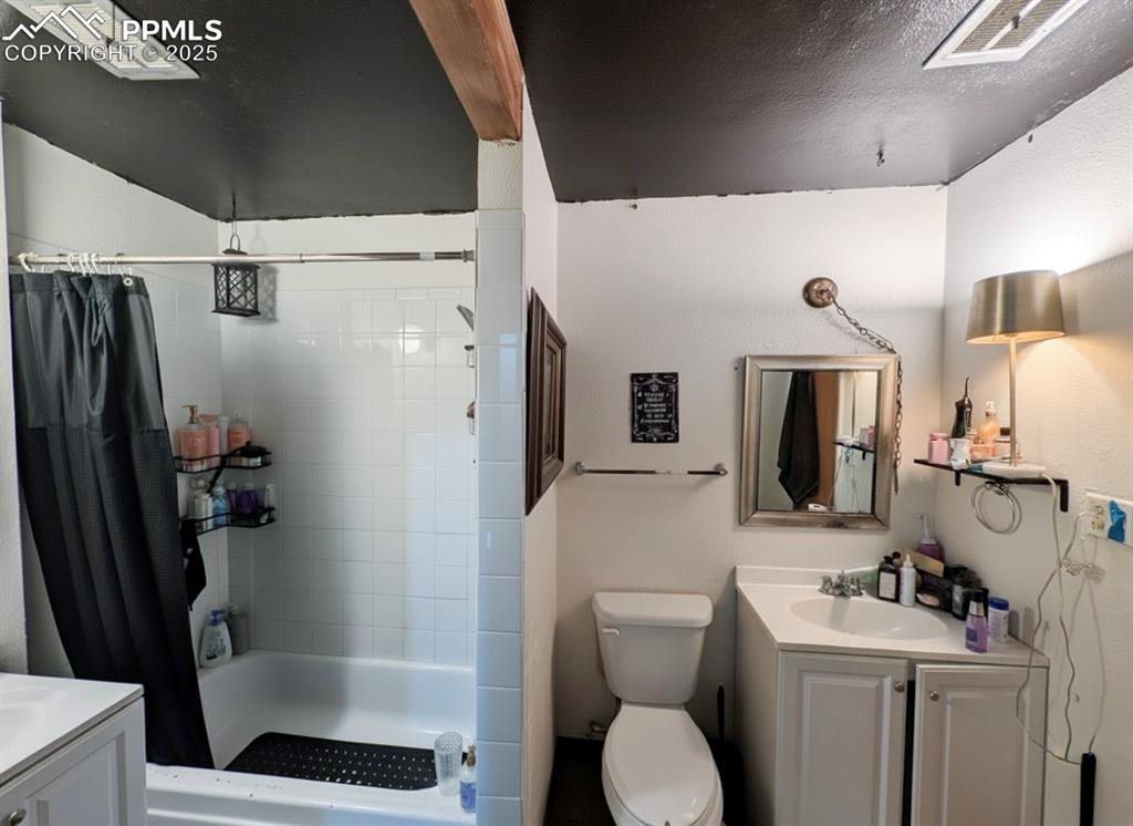 Bathroom with vanity and a textured ceiling