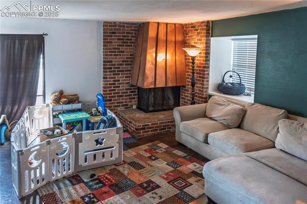 Living room featuring a brick fireplace and healthy amount of natural light