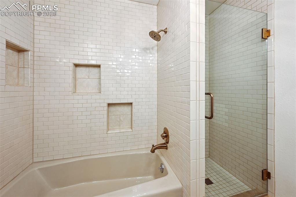 This full-size bathroom has a separate shower and tub area with cut-outs.