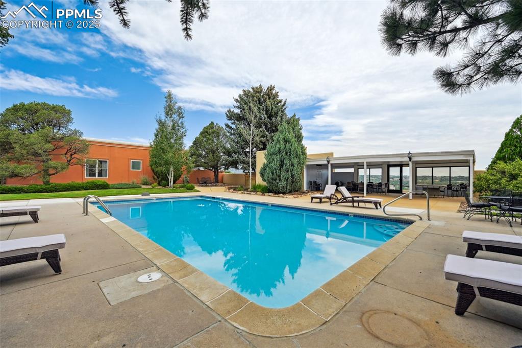 A beautiful pool area for the residents with lounge chairs ready for sun, relaxation, and a cool dip!
