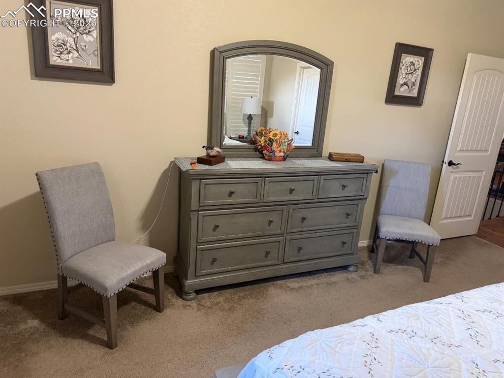 Bedroom featuring light carpet