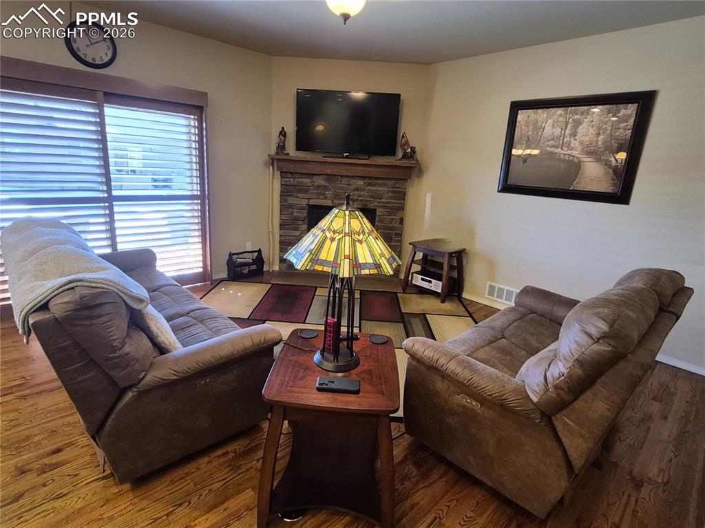 Living area featuring wood finished floors and a fireplace