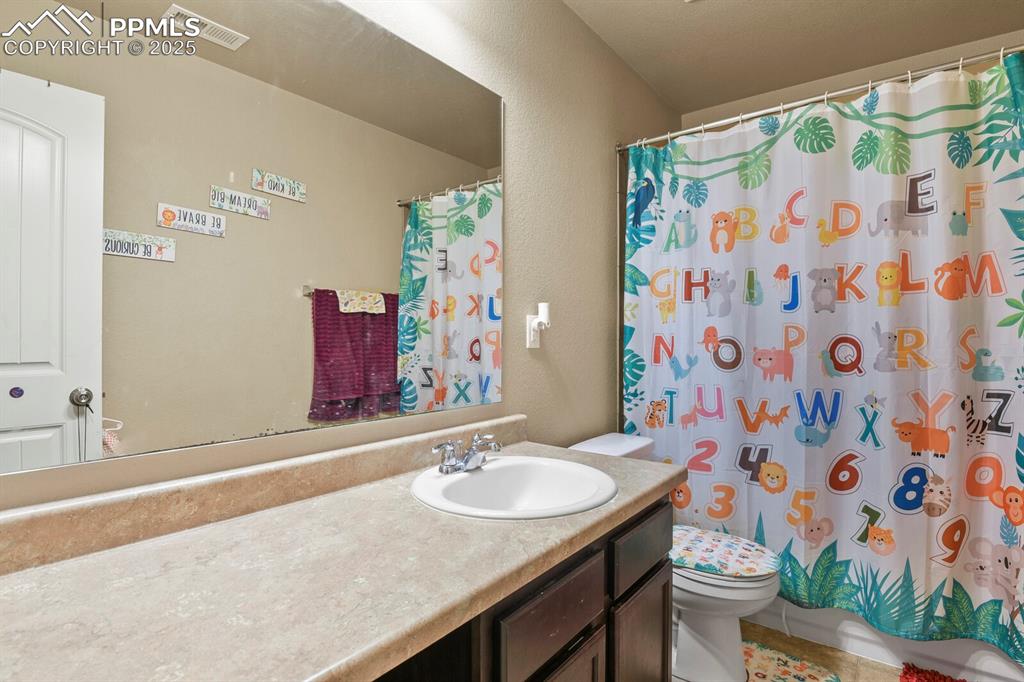 Bathroom with vanity and a shower with shower curtain