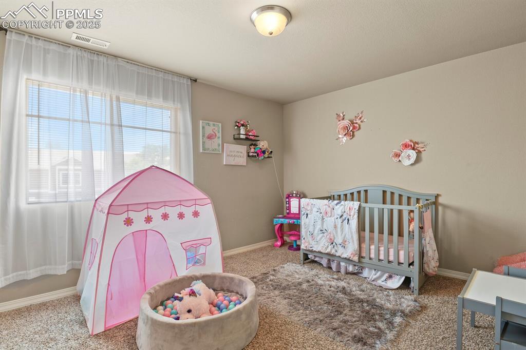 Carpeted bedroom with baseboards